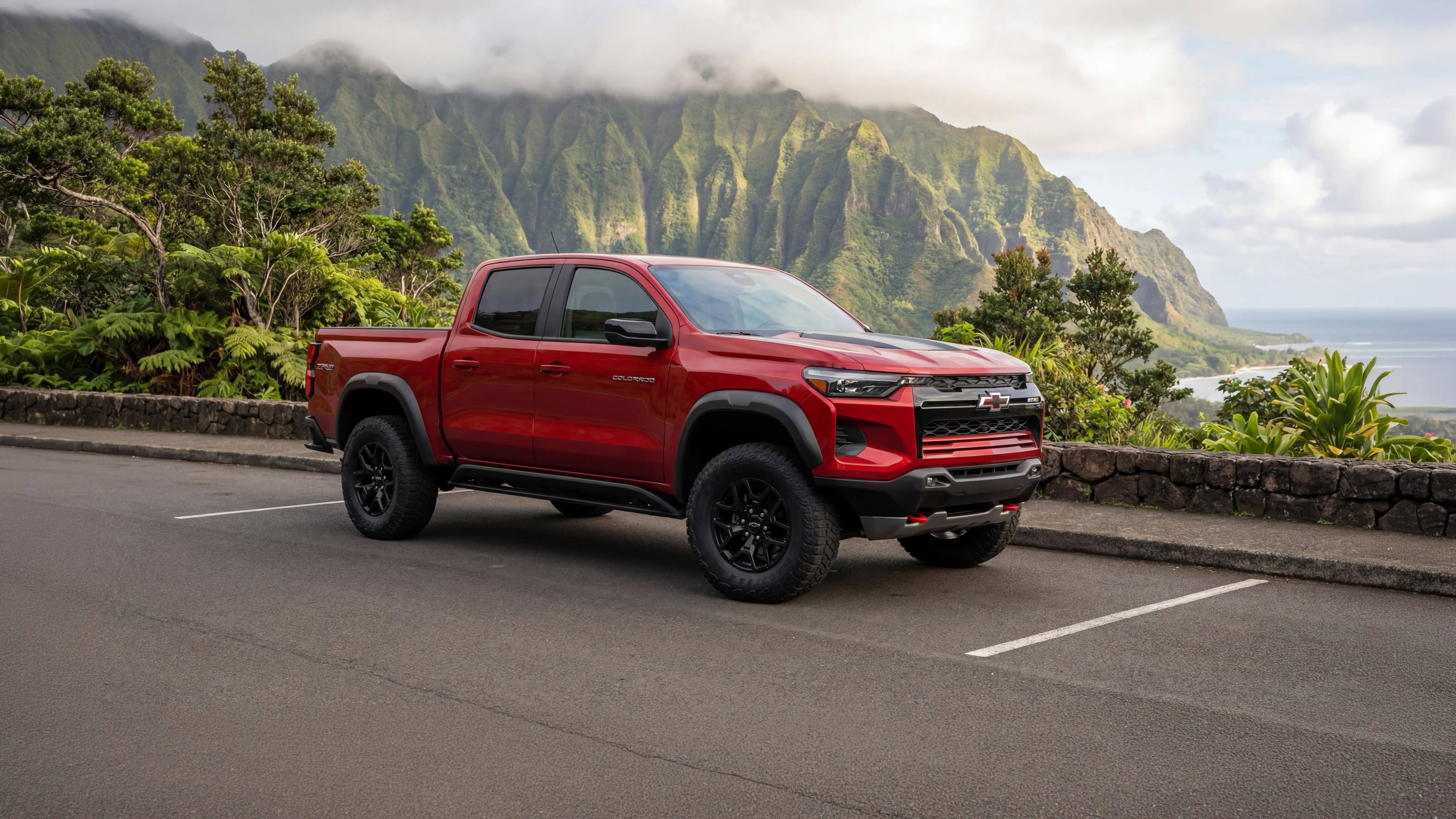 Red Chevrolet Colorado ZR2 off-road truck parked at a scenic mountain overlook in Hawaii.