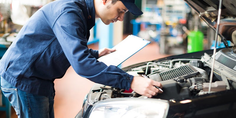 Technician servicing a car